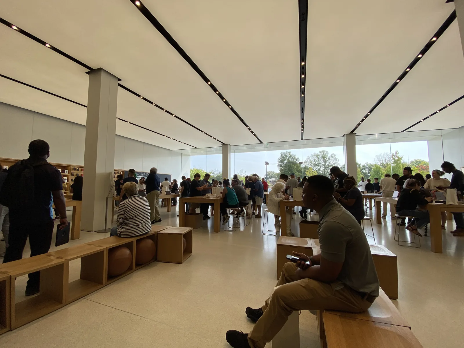 Shoppers at the long wooden tables inside the Apple store at Saddle Creek in Germantown.