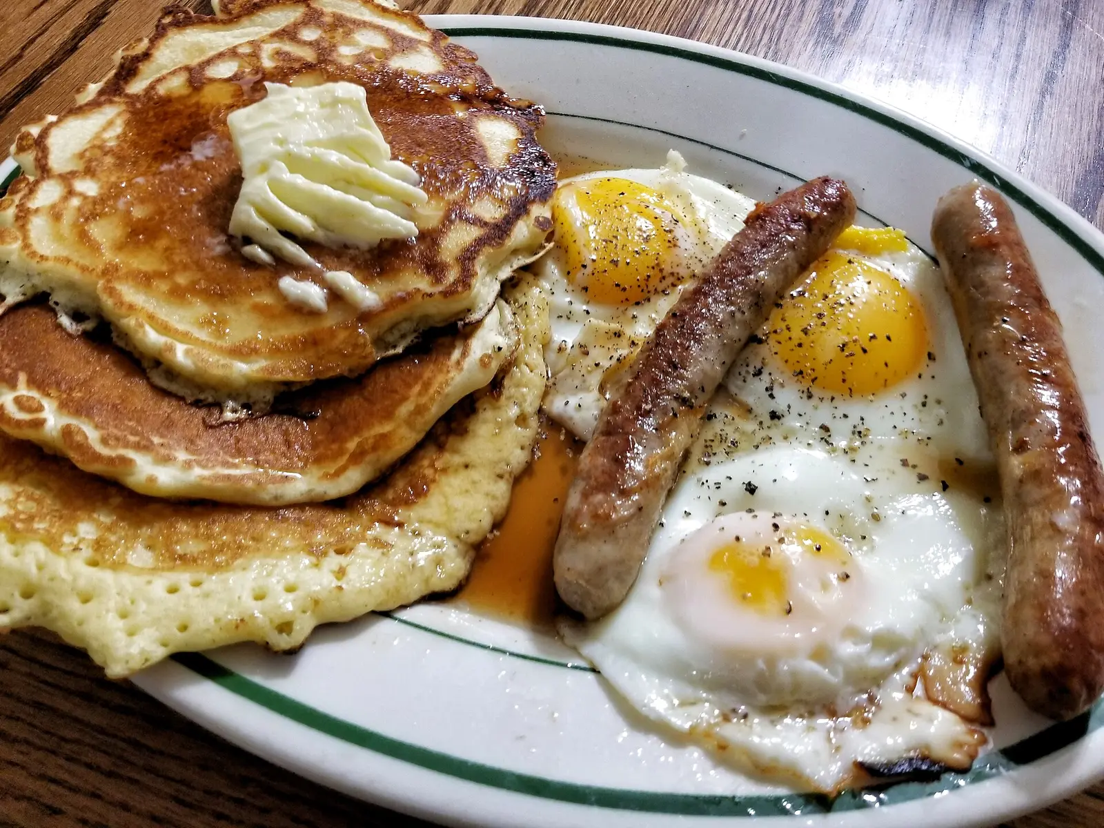 Pancakes with butter, fried eggs and sausage links on a diner plate. The photo was not taken at a Germantown restaurant.