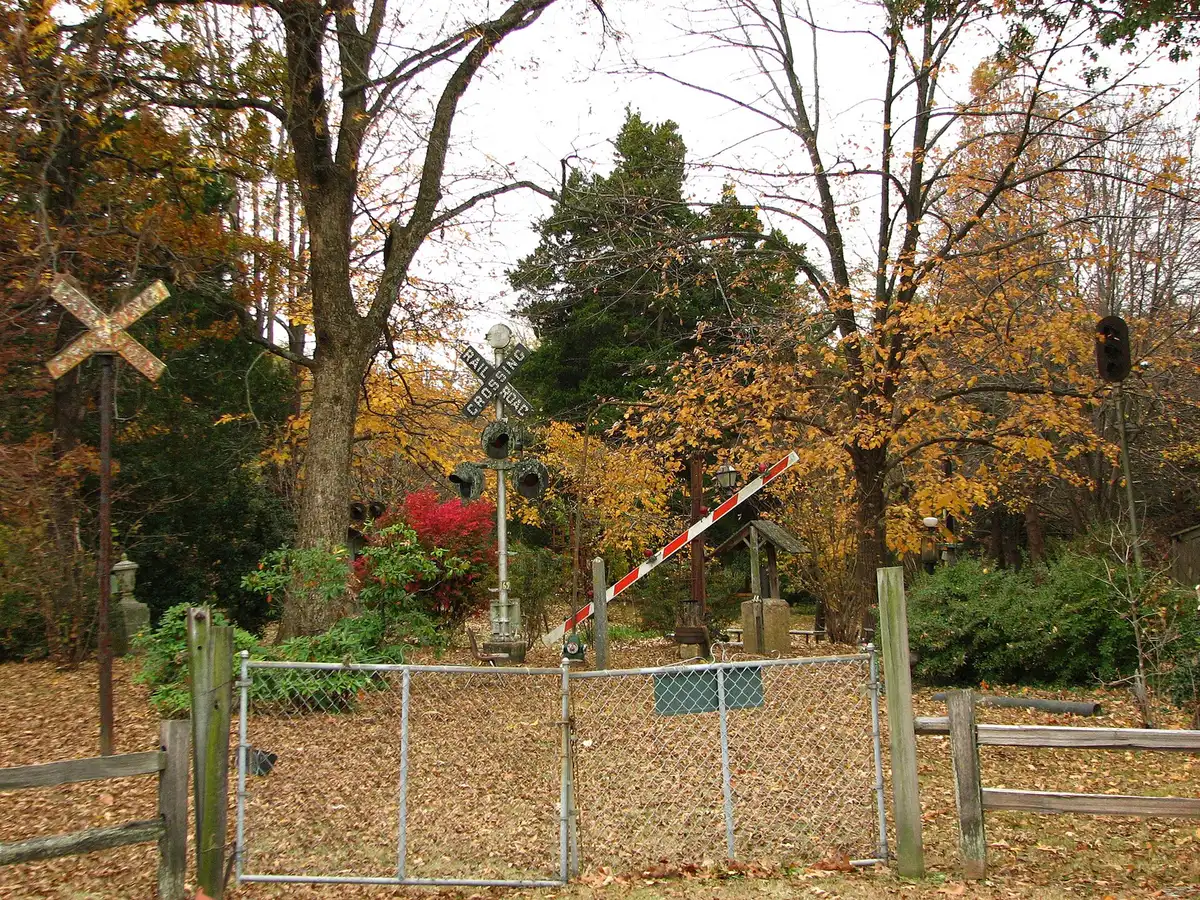 Fall leaves and the old railroad crossing signals at Oaklawn Garden on Poplar Pike, beside the wooded trail to Bobby Lanier Farm Park.