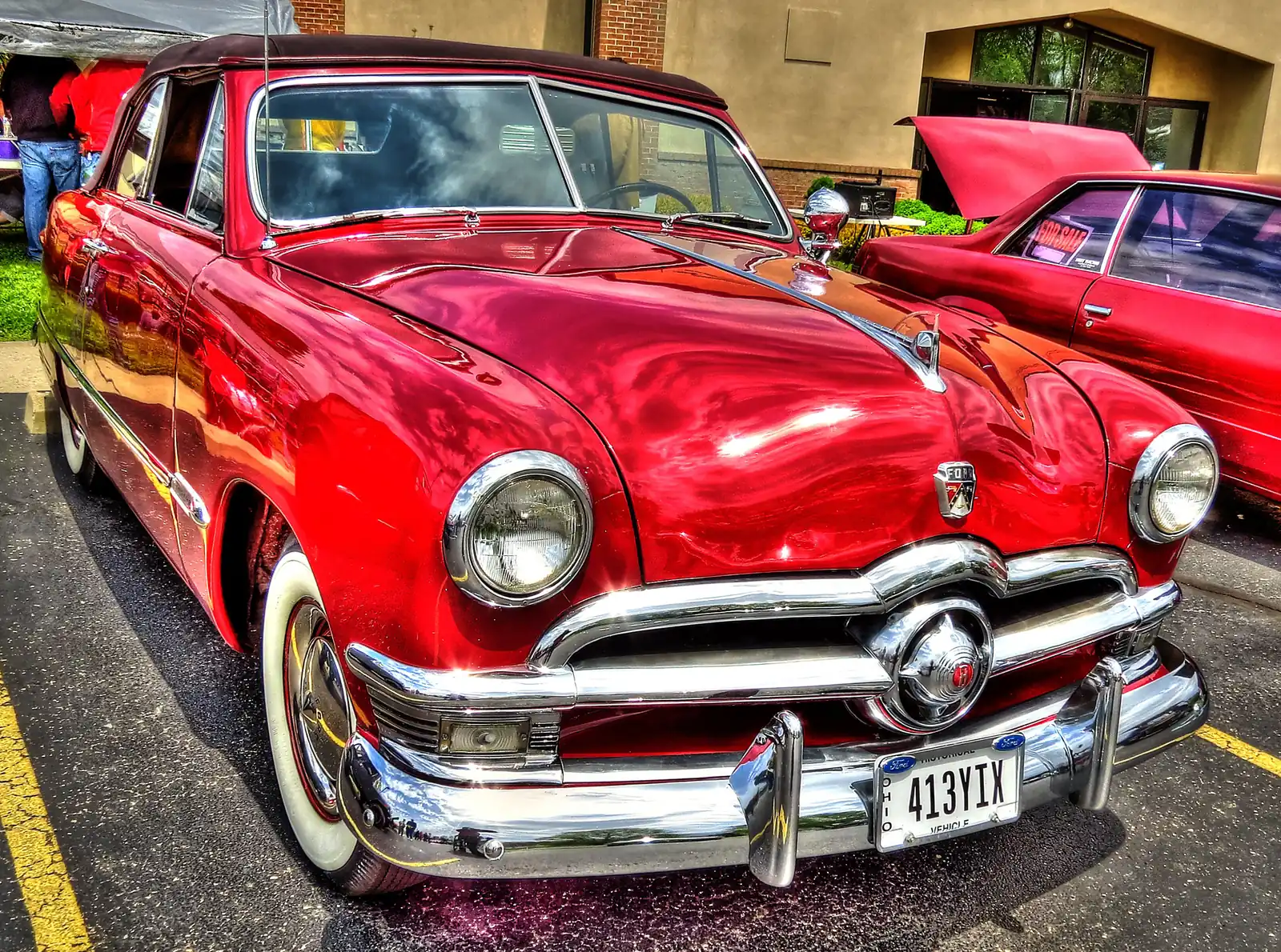 A restored red 1950 Ford convertible on display at a church parking lot car show in Waverly, Ohio.
