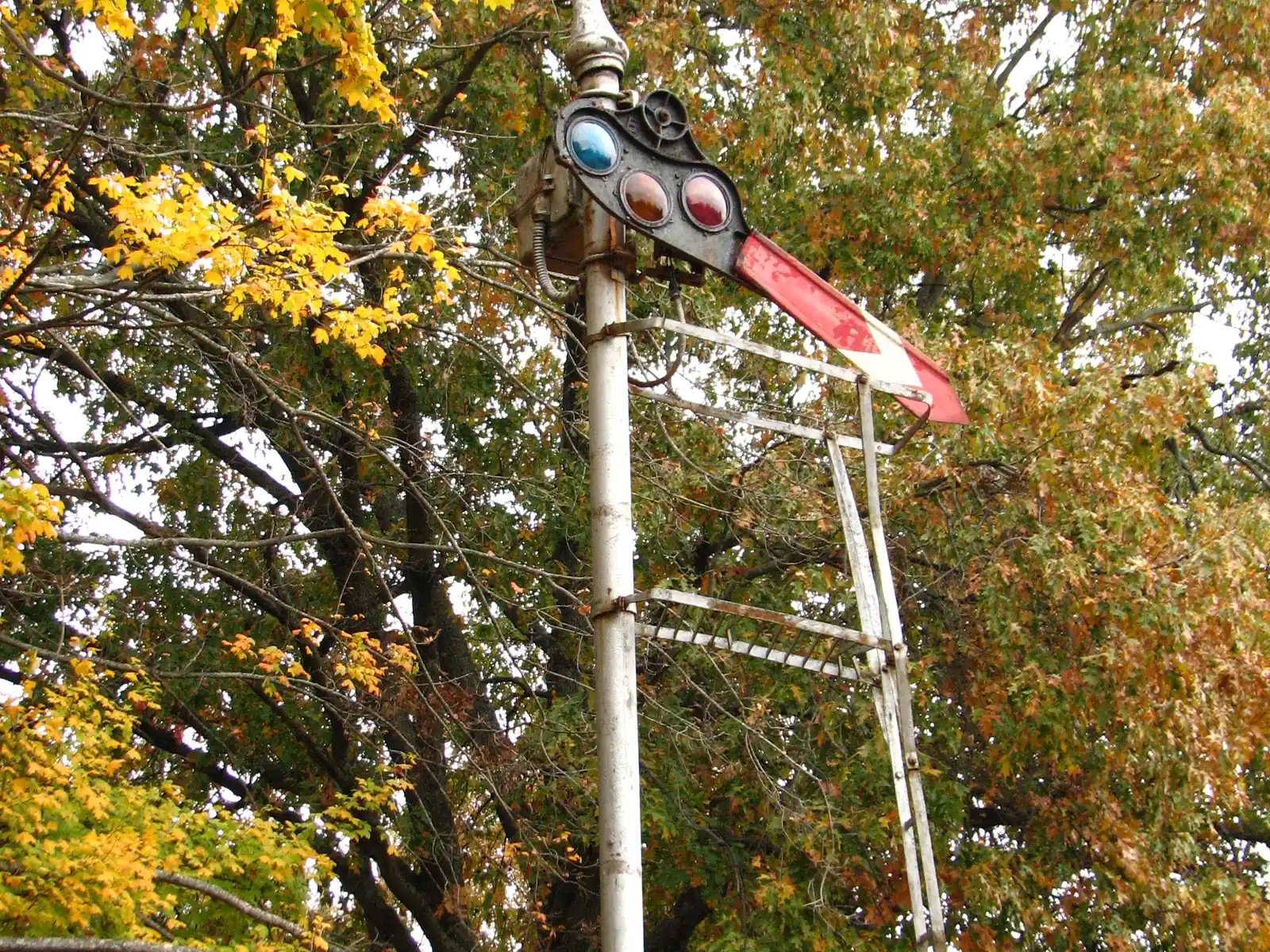 An old railroad semaphore signal among fall trees at Oaklawn Garden on Poplar Pike, a short walk from C.O. Franklin Park, home of the Germantown Festival.