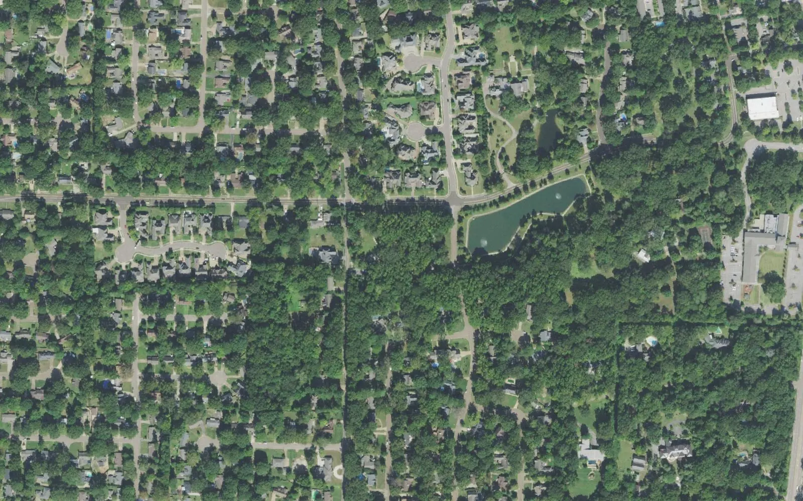 Wooded residential streets on Germantown's southwest side around McVay Road, seen from the air, with a pond at upper right