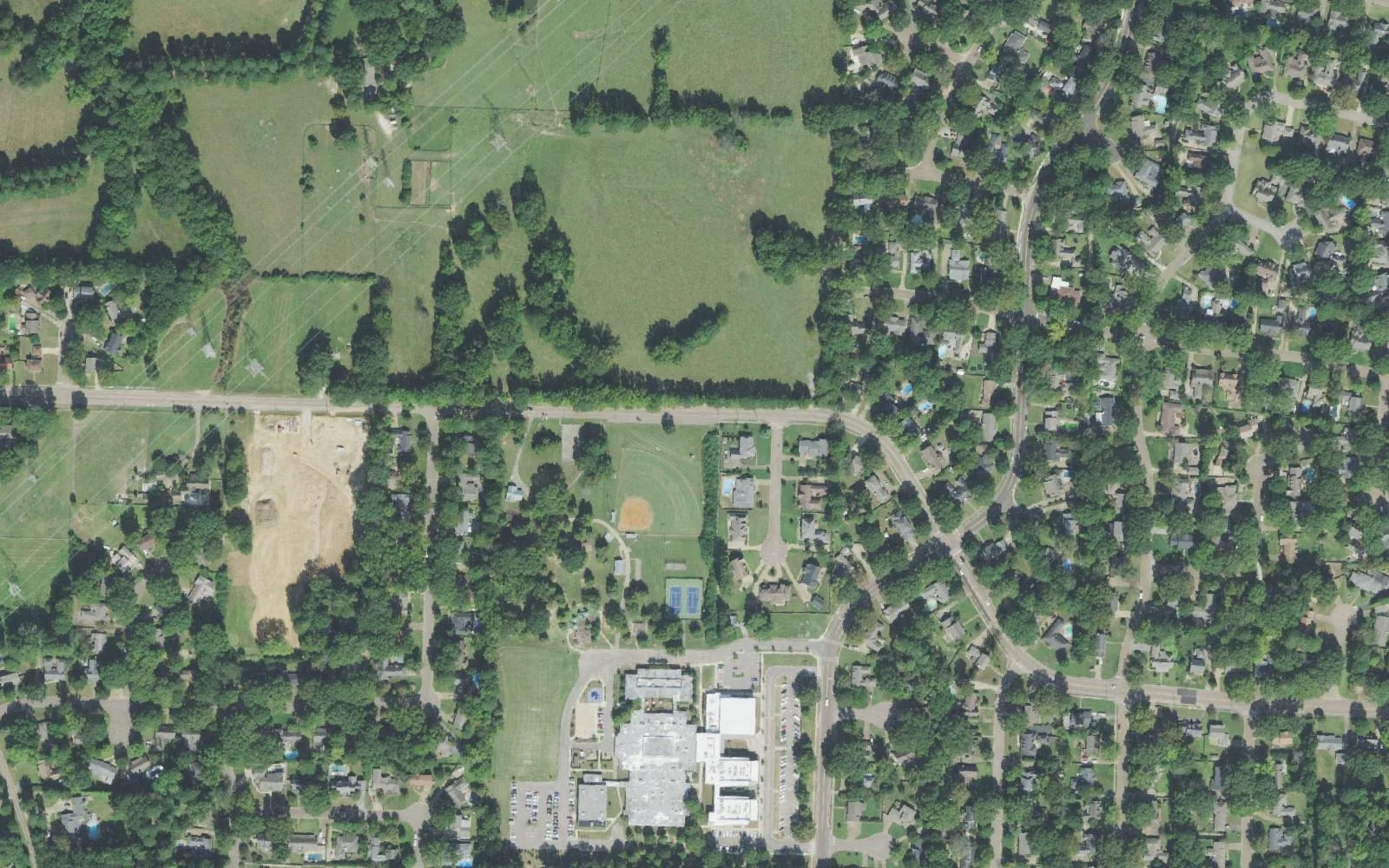 Riverdale K-8 school and the ball fields of Riverdale Park on Neshoba Road in Germantown, seen from the air among wooded residential streets
