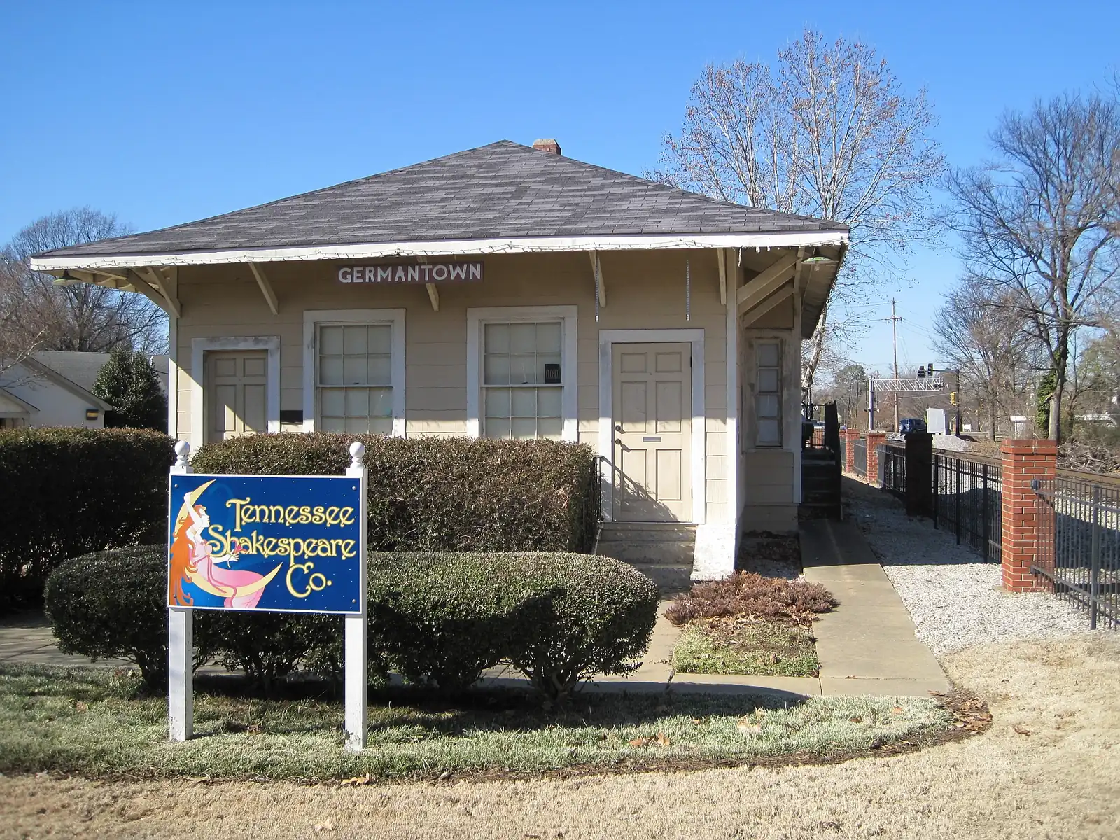 The Germantown Train Depot, rebuilt after a 1947 fire, behind its hedges and sign on West Street in Old Germantown.