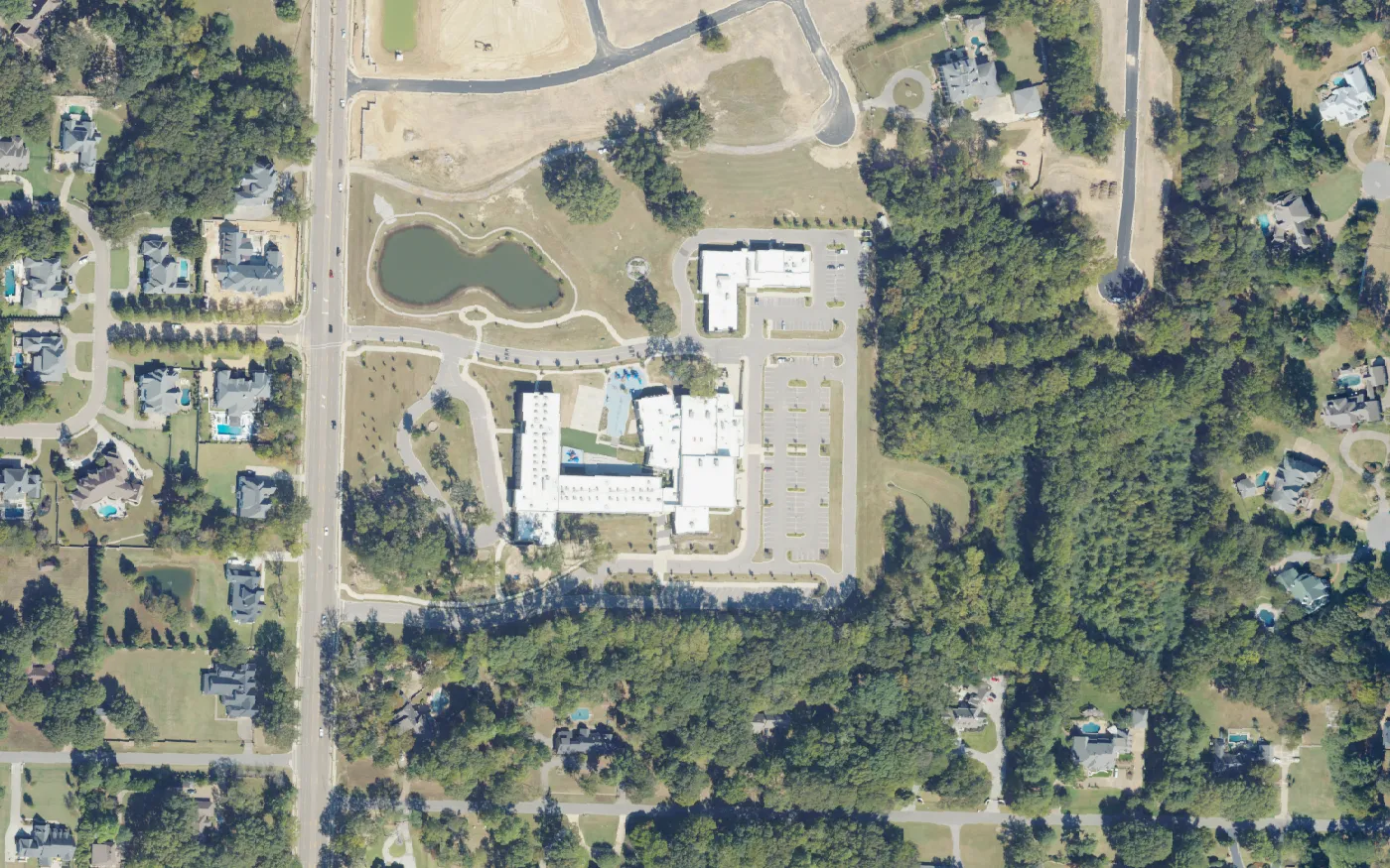 Forest Hill Elementary School, its pond and the school district's campus on South Forest Hill-Irene Road in Germantown, seen from the air.