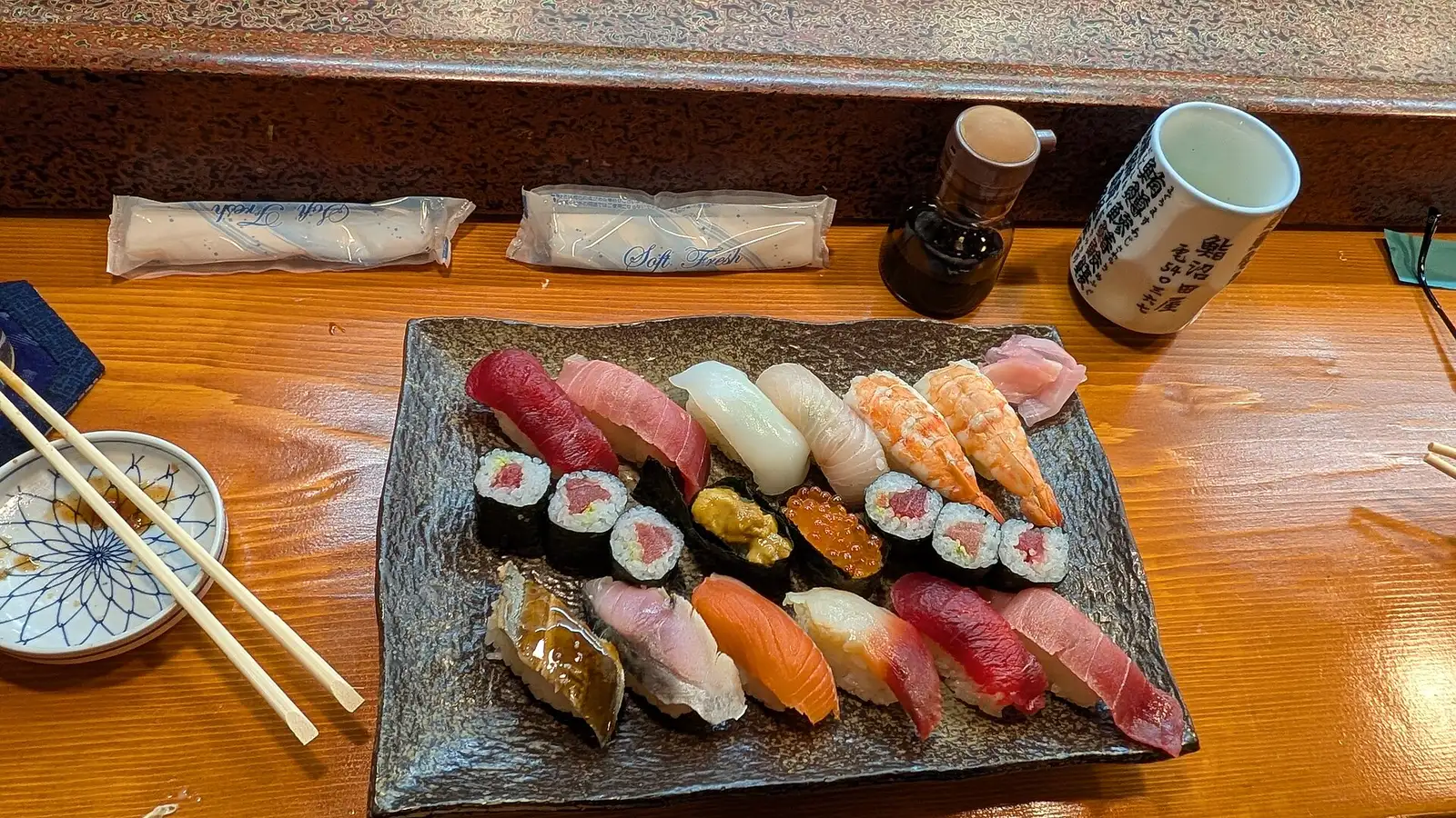 A platter of nigiri and maki sushi on a restaurant counter in Nikko, Japan.