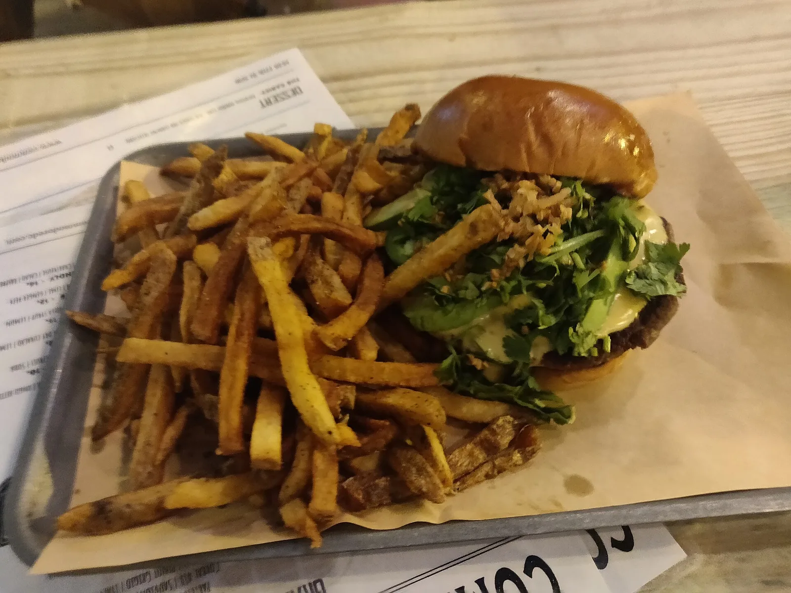 A cheeseburger with greens and a tray of fries. The photo was not taken at a Germantown restaurant.